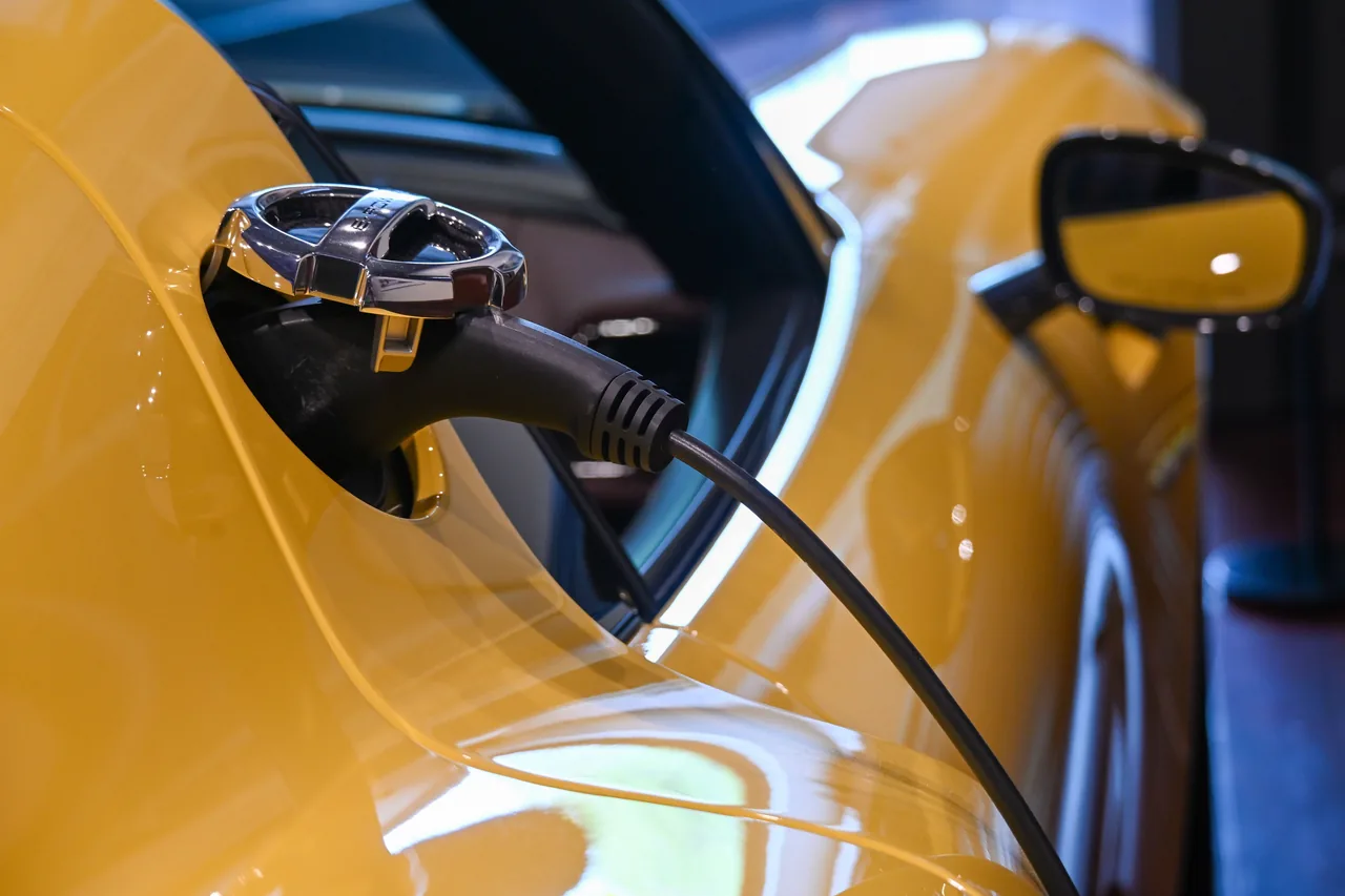 Ladekabel am Ladeanschluss eines gelben Elektroautos